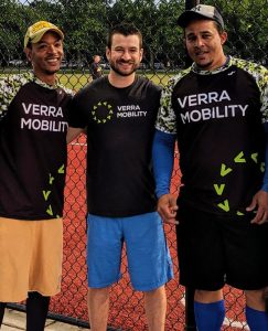 Three Verra Mobility employees playing softball