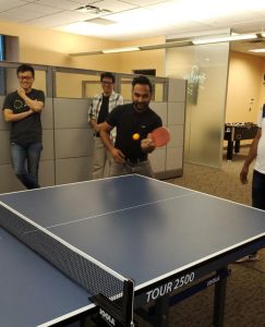 4 Verra Mobility employees playing ping pong