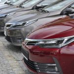 Toyota Corolla cars stopped on the parking in a row. The Corolla is one of the most popular cars in the world.