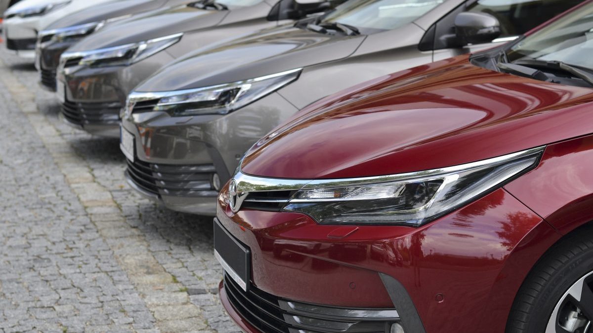 Toyota Corolla cars stopped on the parking in a row. The Corolla is one of the most popular cars in the world.