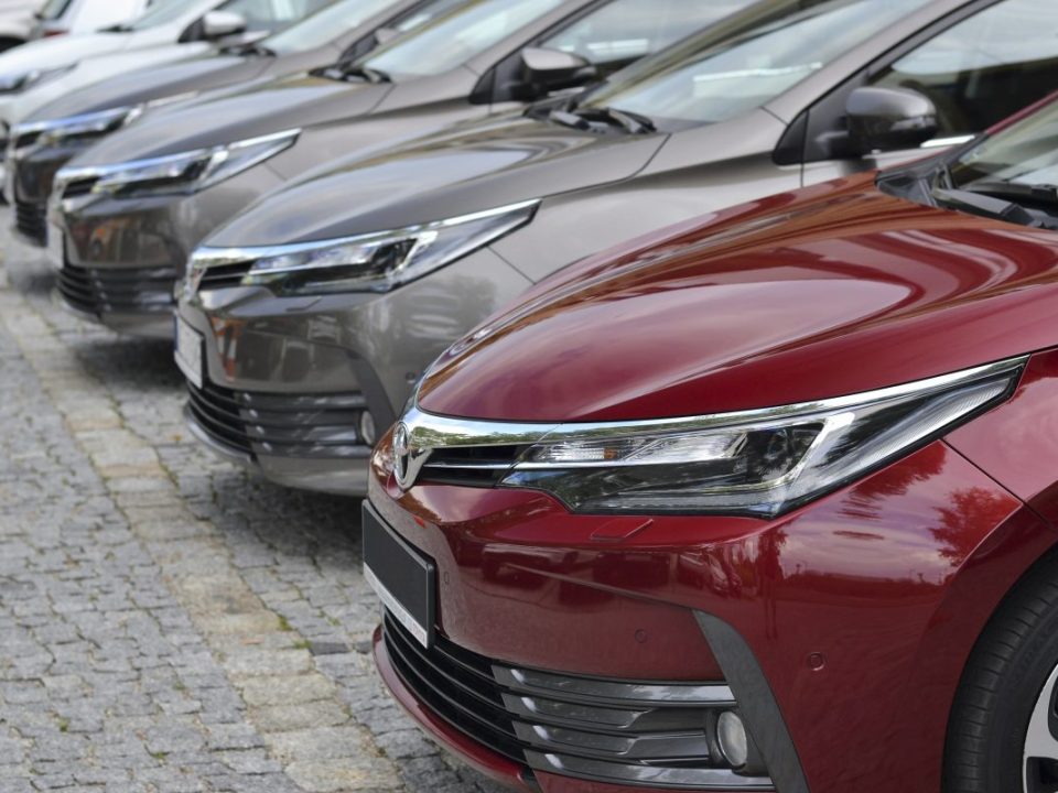 Toyota Corolla cars stopped on the parking in a row. The Corolla is one of the most popular cars in the world.