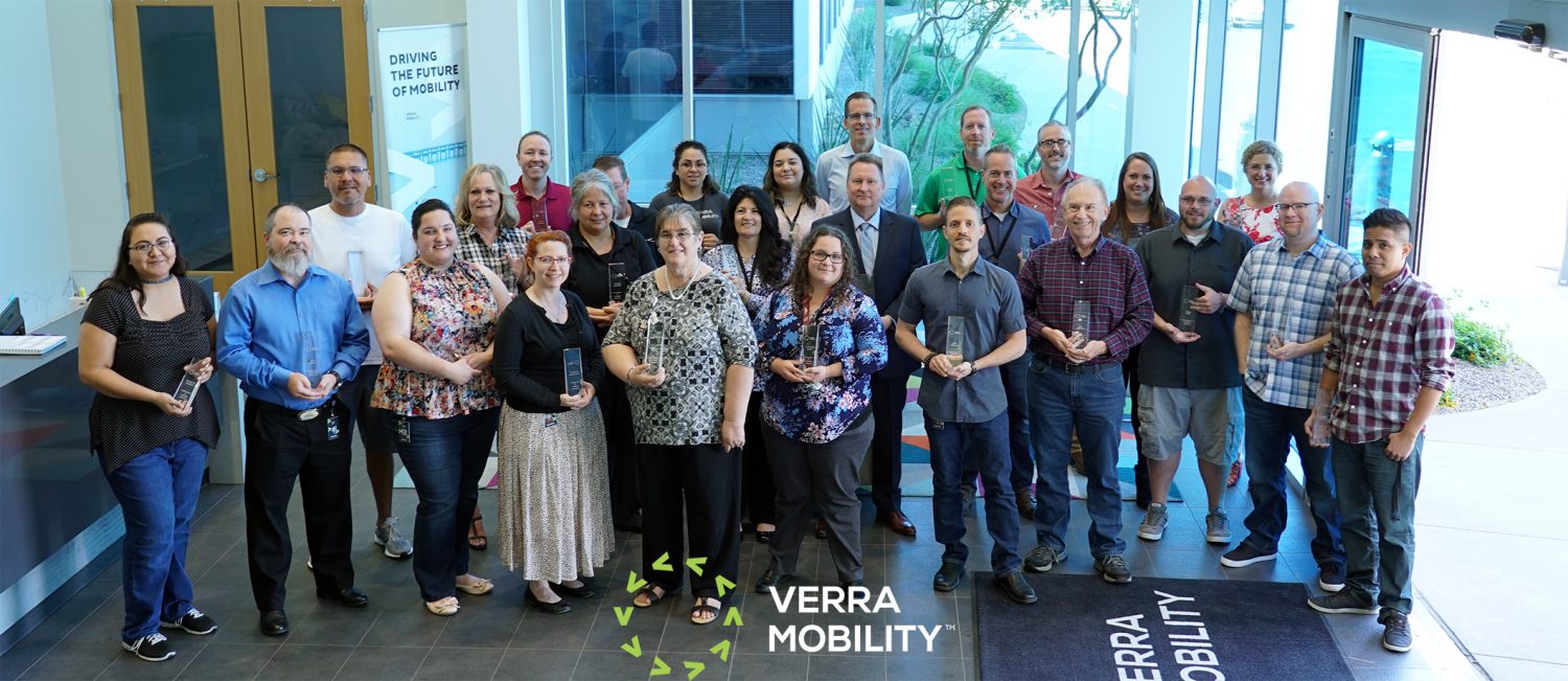 Verra mobility team members smiling with awards