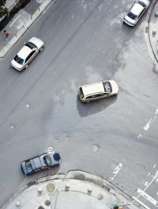Cars turning on street viewed from above