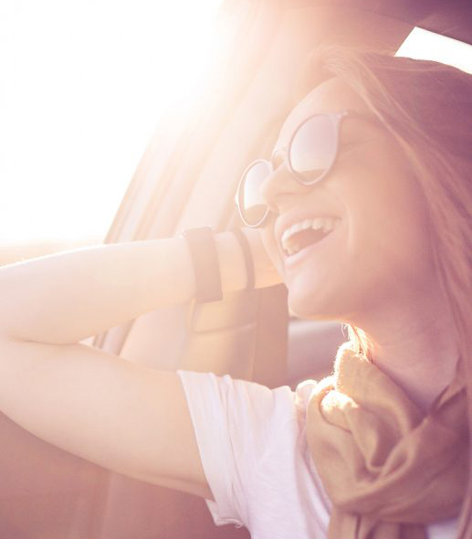 Woman In Car With Glasses Smiling