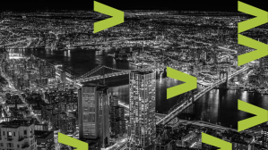 Black and white city scape and night with bright lights and cars moving along bridges