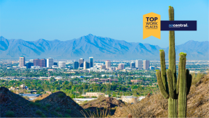 Phoenix city scene with mountains in background and cactus foreground with Top Work Place badge from azcentral
