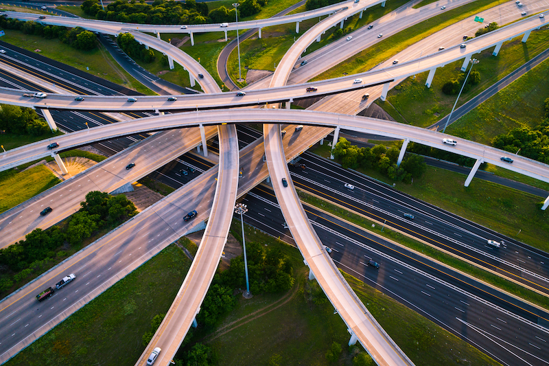 Aerial view of a highway interchange loops and turnarounds.