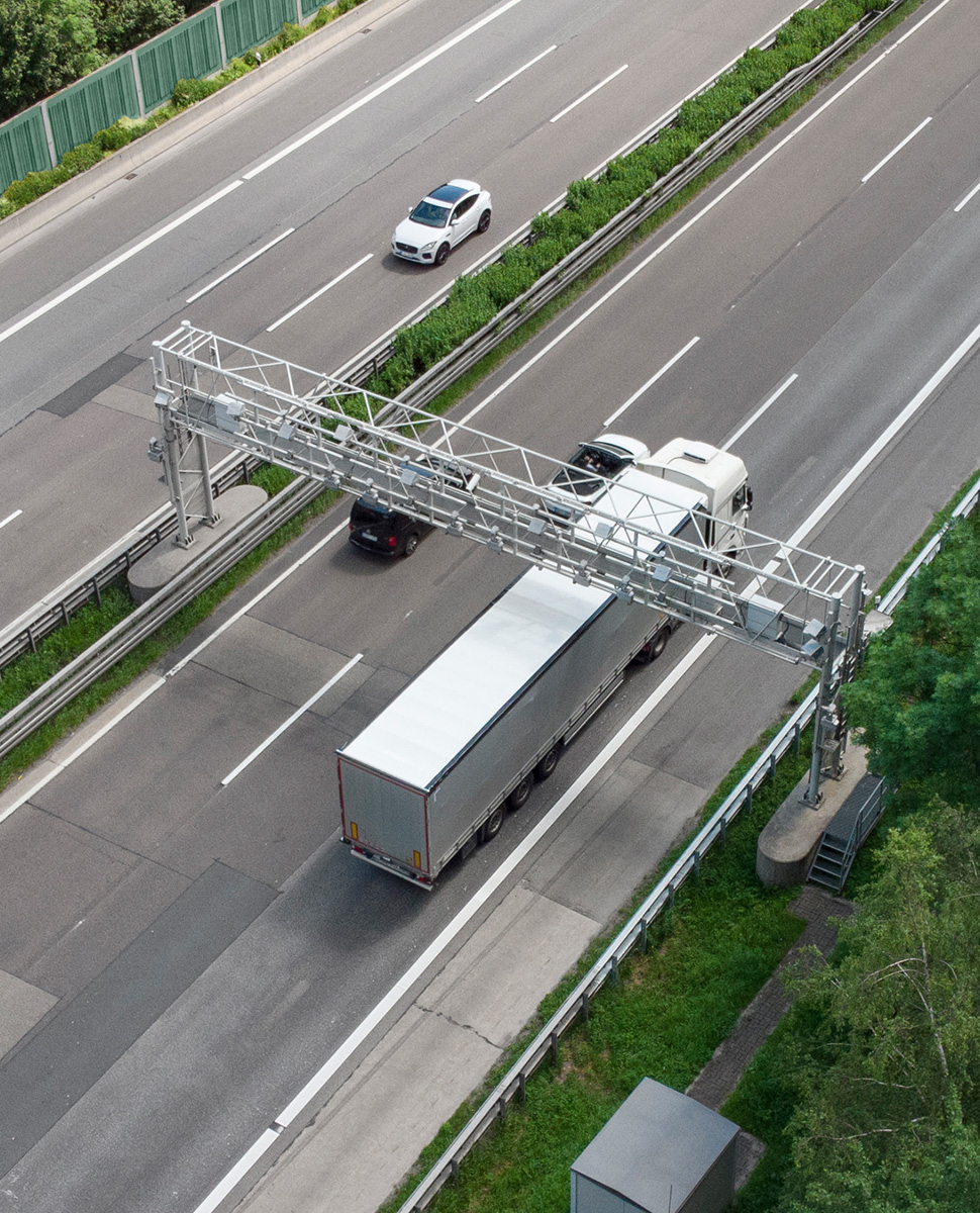 Truck driving through toll gantry