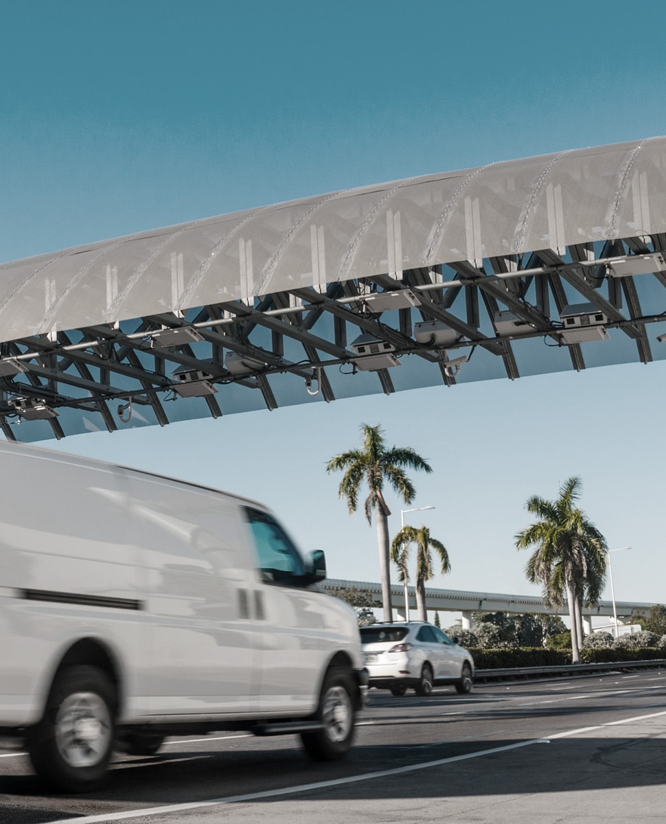 Fleet vehicle driving through toll gantry