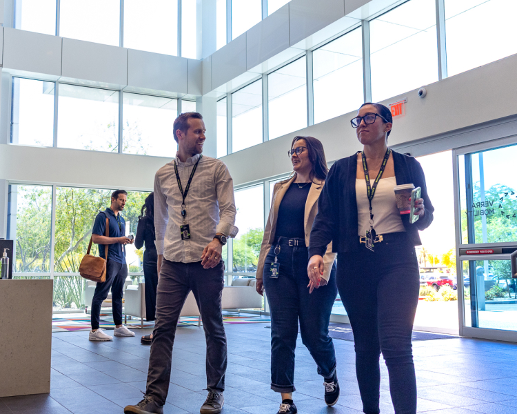 Employees walking in lobby in office