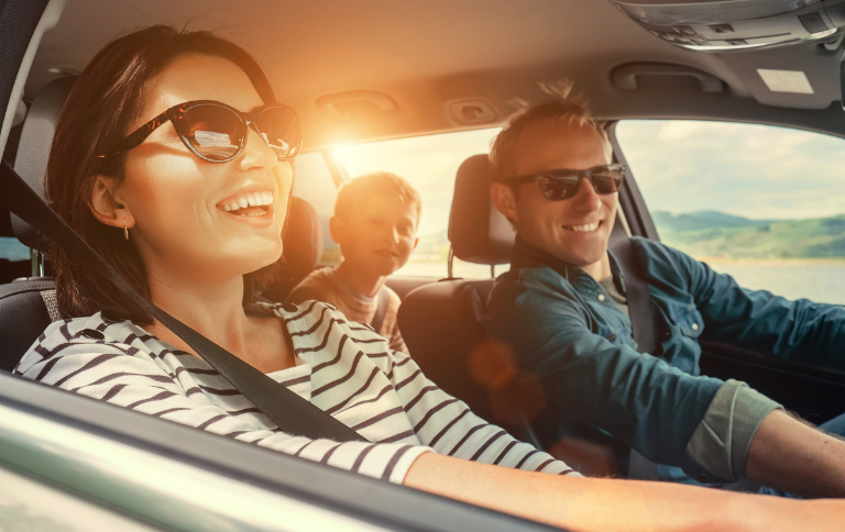 Couple driving in car smiling