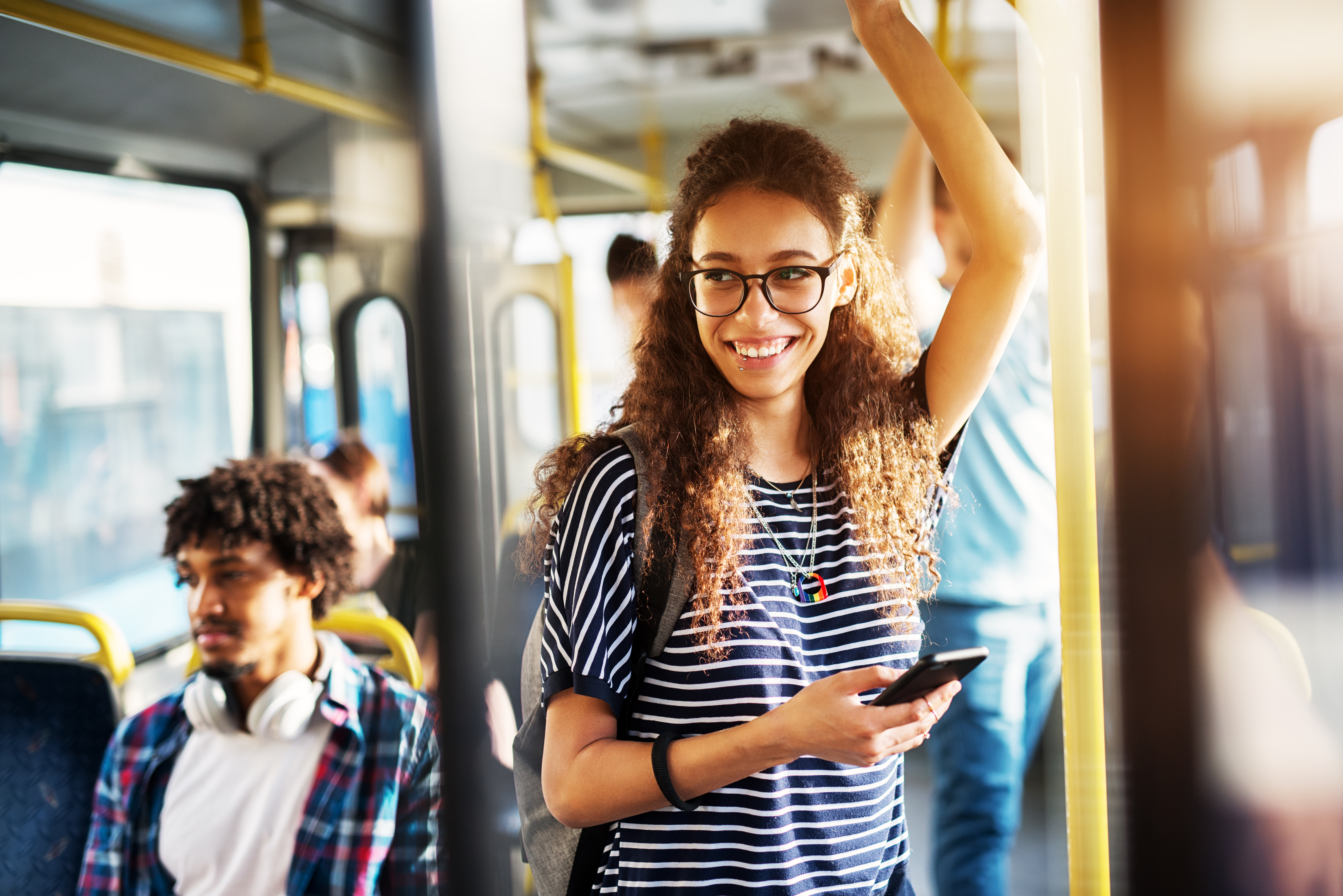 Young cheerful woman riding bus