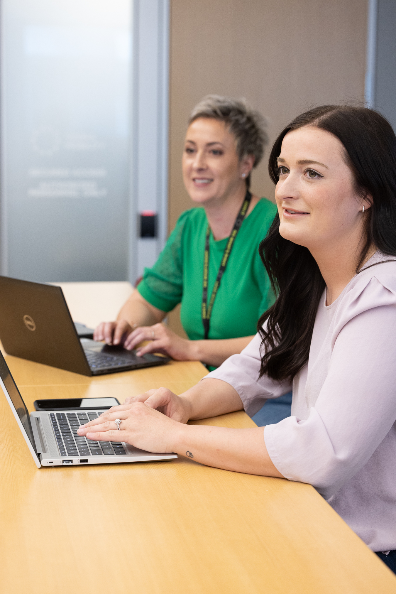 Company employees looking at computers