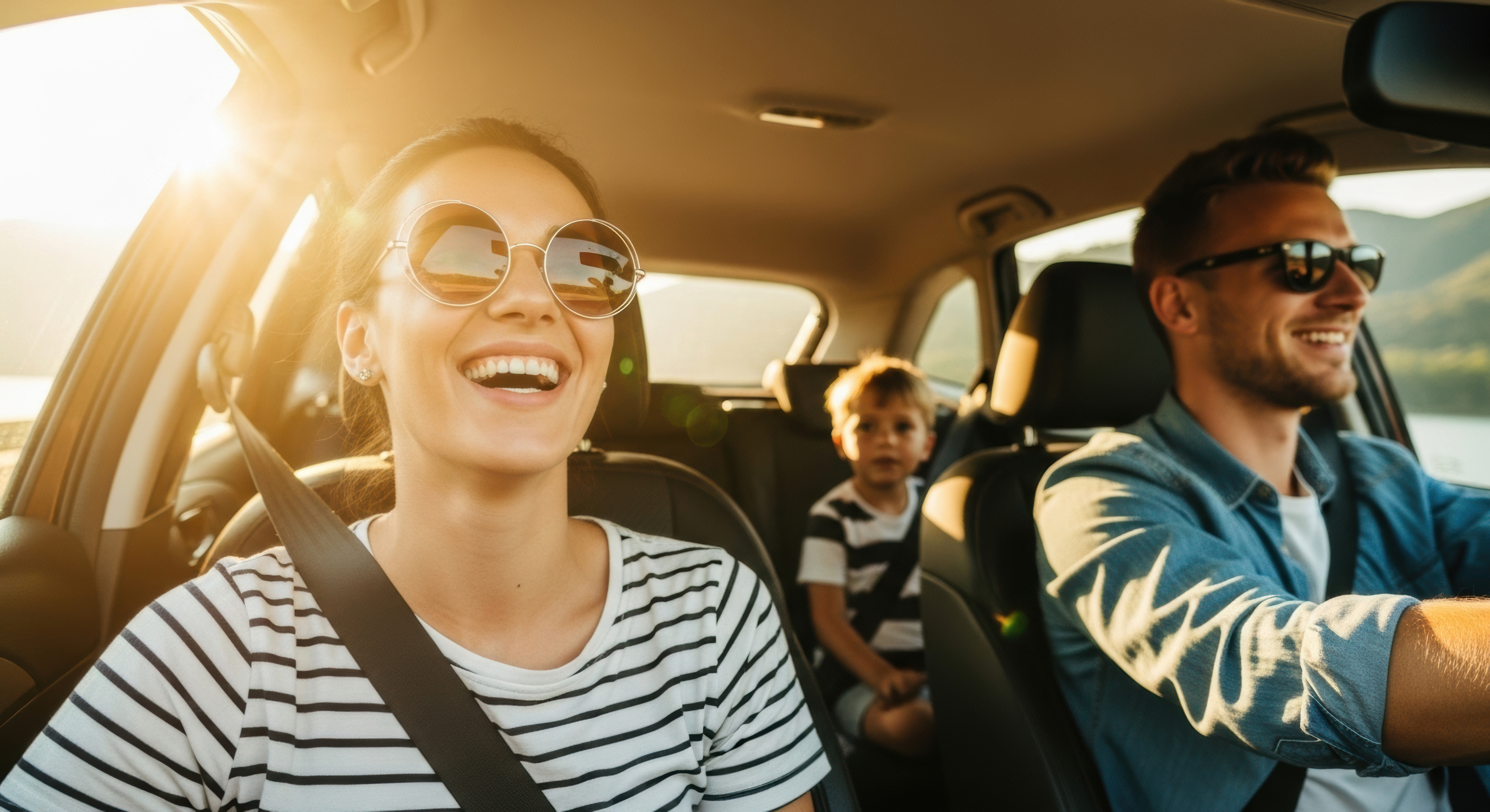 family driving in car during the summer