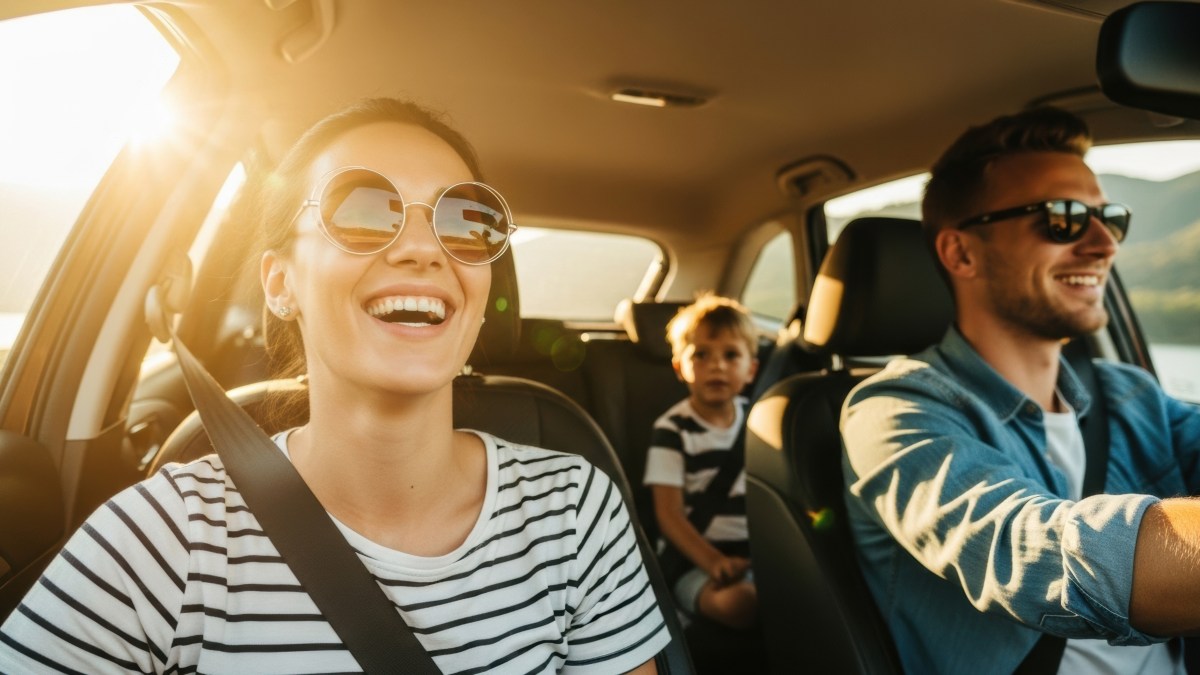 family driving in car during the summer