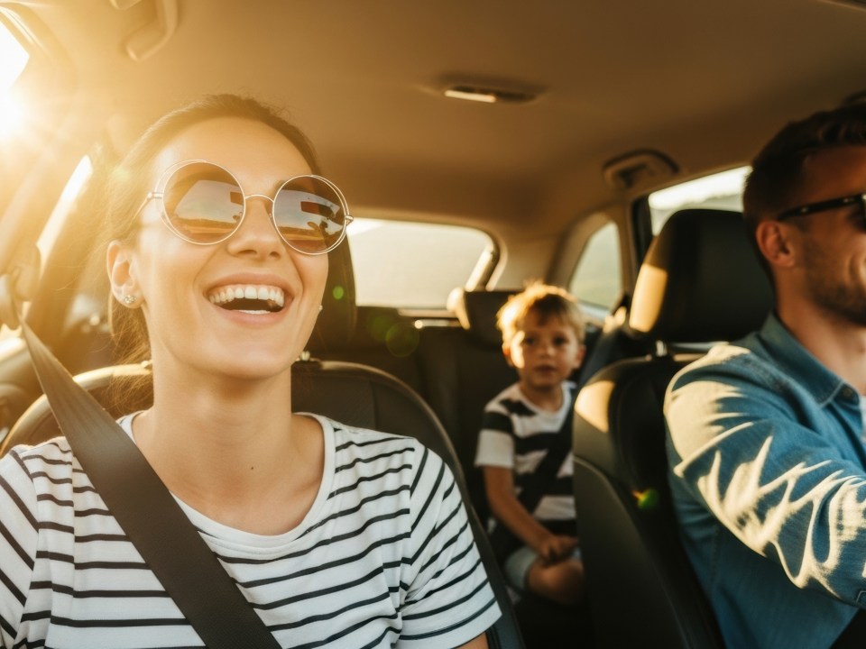 family driving in car during the summer