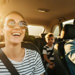 family driving in car during the summer