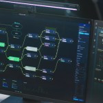software engineer looks at computer screen with displayed big data server and blockchain network, monitors real-time analysis charts in monitoring office.